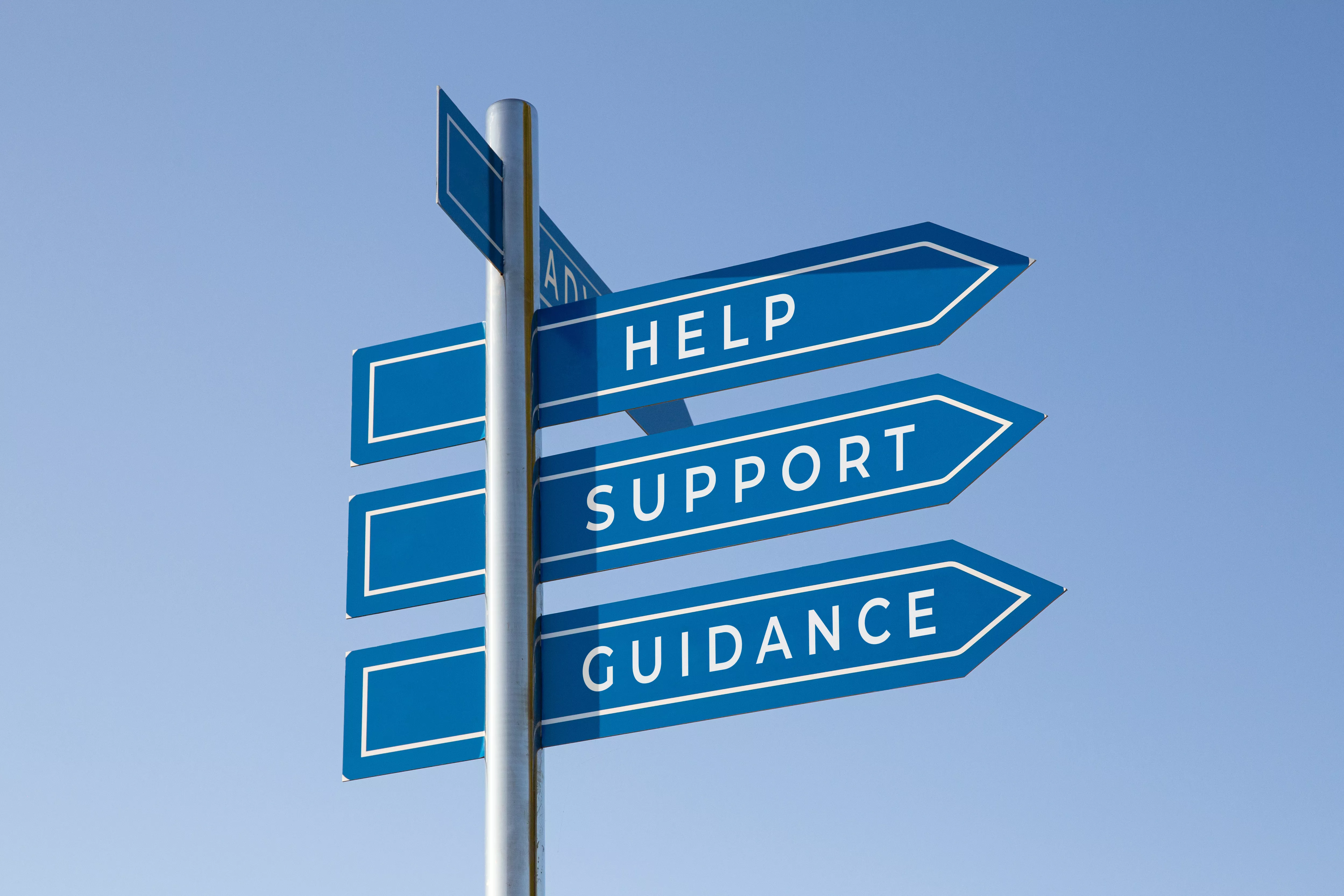 A signpost with the words, help, support, and guidance on it